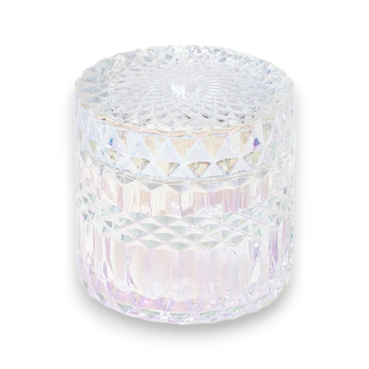 Iridescent vintage crystal candle jar against a white background