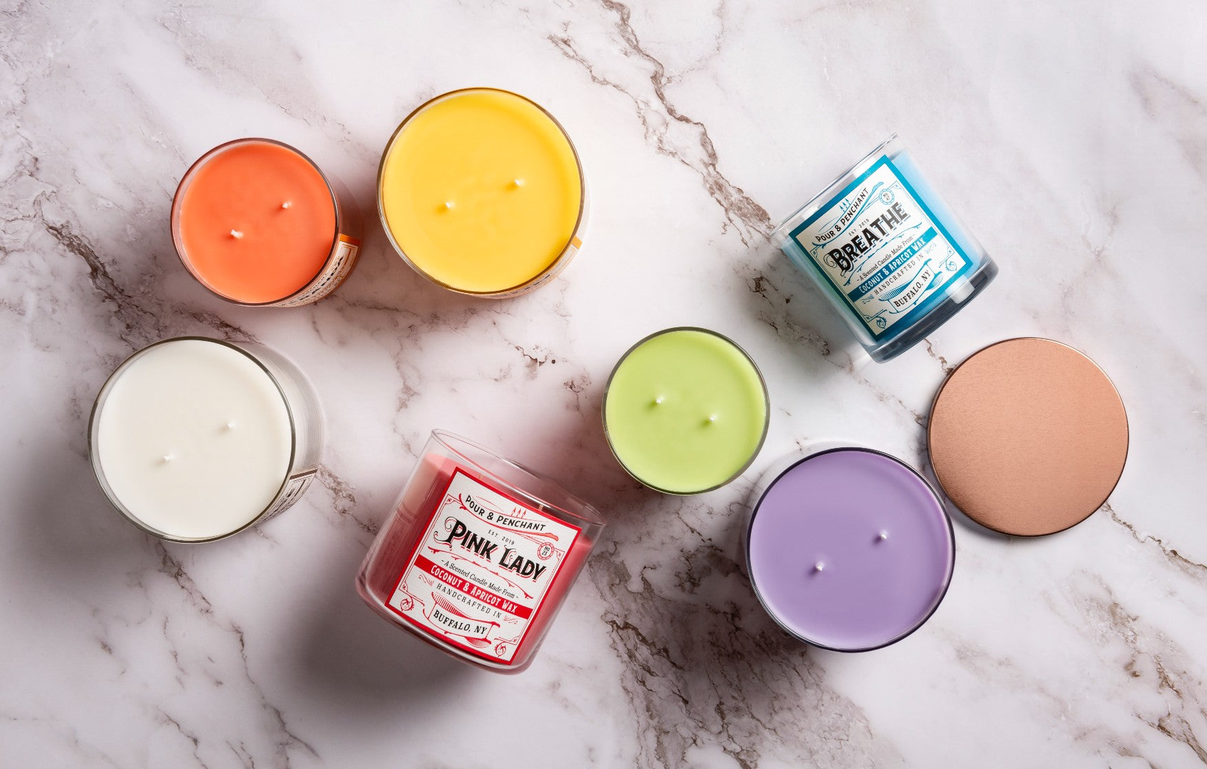 A collection of Pour & Penchant hand poured, multi-wick, scented candles showing bestsellers, Pink Lady and Breathe