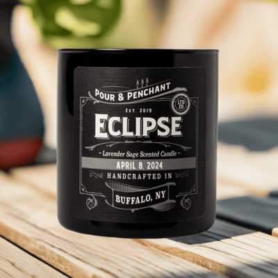 Pour & Penchant 10 oz Eclipse Scented Candle on a wooden deck with a blurred summer background