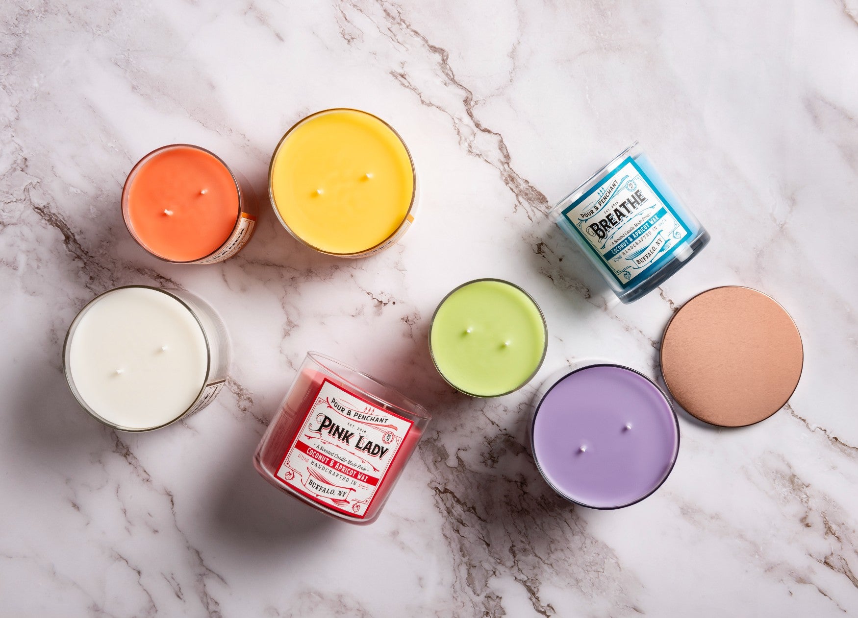 A collection of Pour & Penchant hand poured, multi-wick, scented candles showing bestsellers, Pink Lady and Breathe